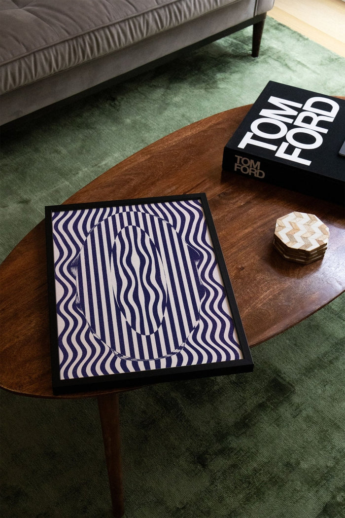 Abstract blue and white striped artwork titled 0 - Fergus Hannant displayed on a wooden coffee table.