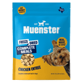 A blue and yellow Muenster dog food bag features a small dog, freeze-dried chicken pieces, and text highlighting it as a complete meal or topper.