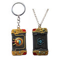 Zelda Purah Pad Keychain, Adventure Symbol: gold, black ornate book-themed design, fantasy, ornate style