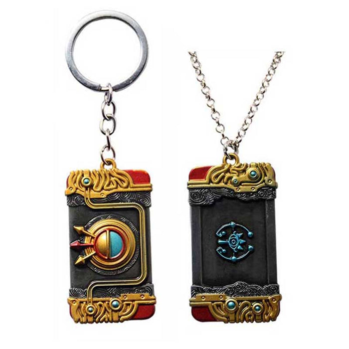 Zelda Purah Pad Keychain, Adventure Symbol: gold, black ornate book-themed design, fantasy, ornate style