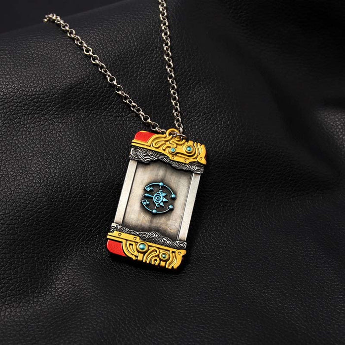 Zelda Purah Pad Keychain, Adventure Symbol: gold, black ornate book-themed design, fantasy, ornate style